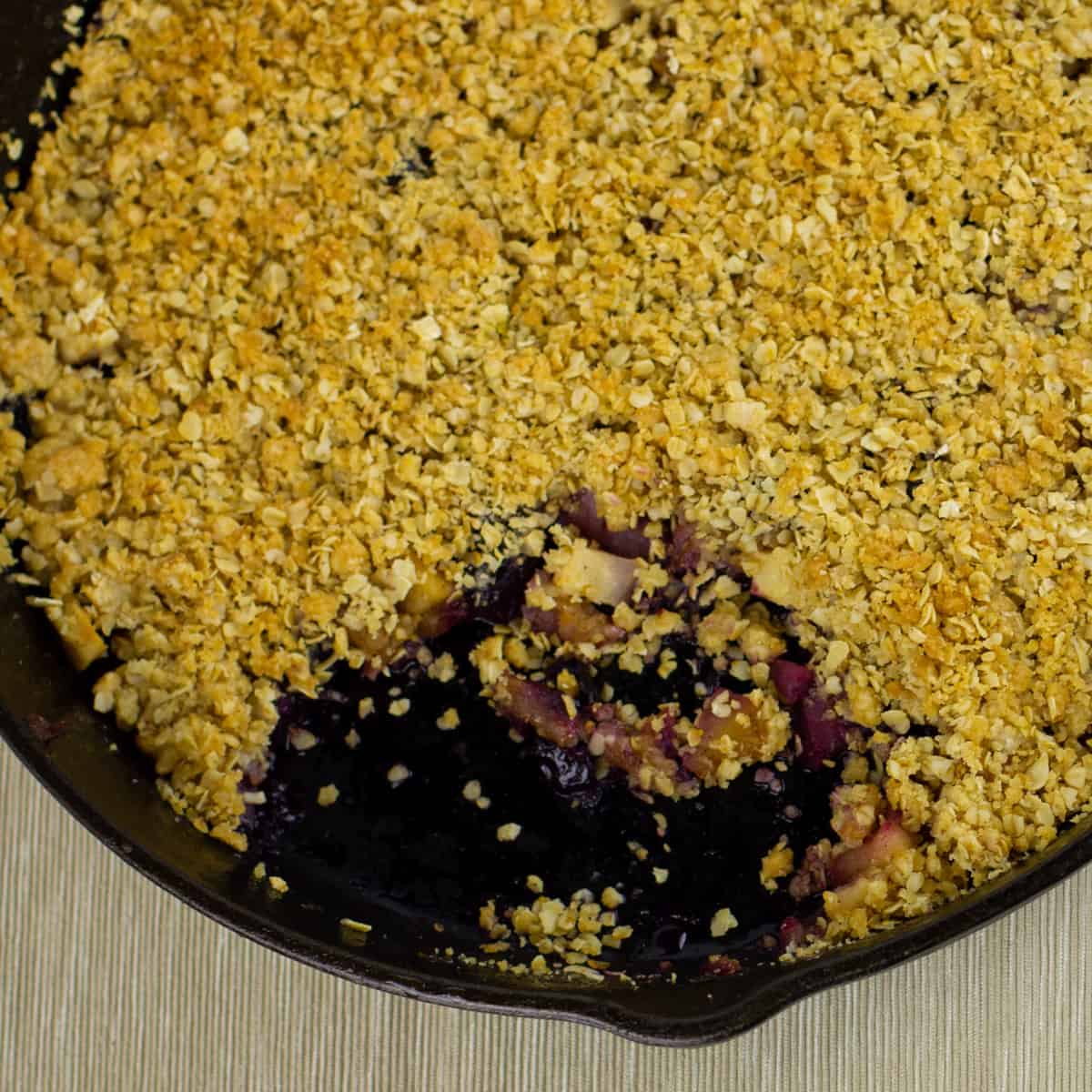 A cast iron skillet with baked crumble.