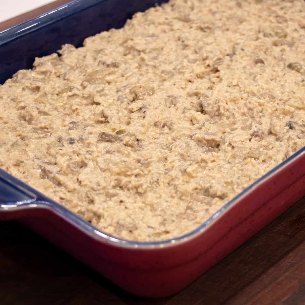 Bottom layer of casserole spread in a baking dish.
