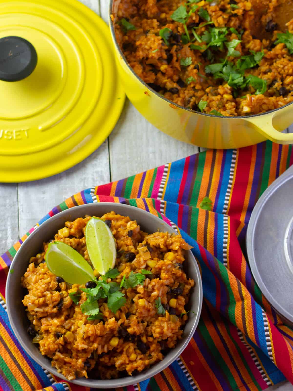 Over head picture of a dutch oven and bowl filled with cooked rice.