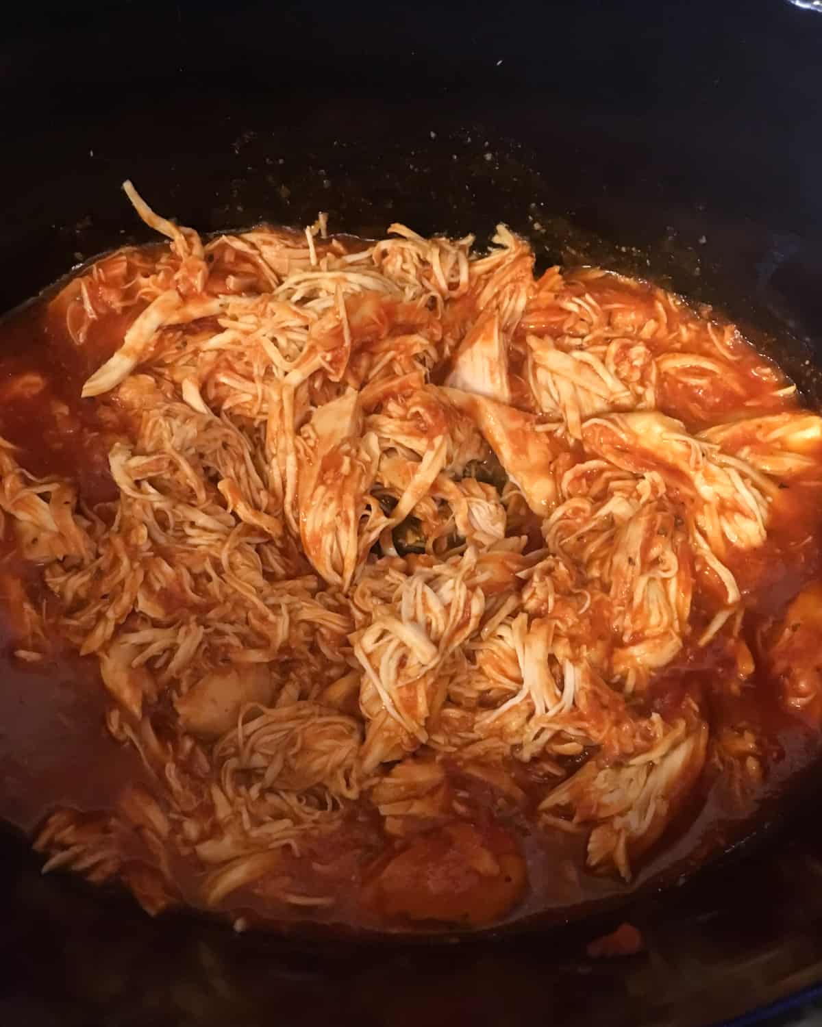 Shredded chicken breast mixed with tomato sauce.