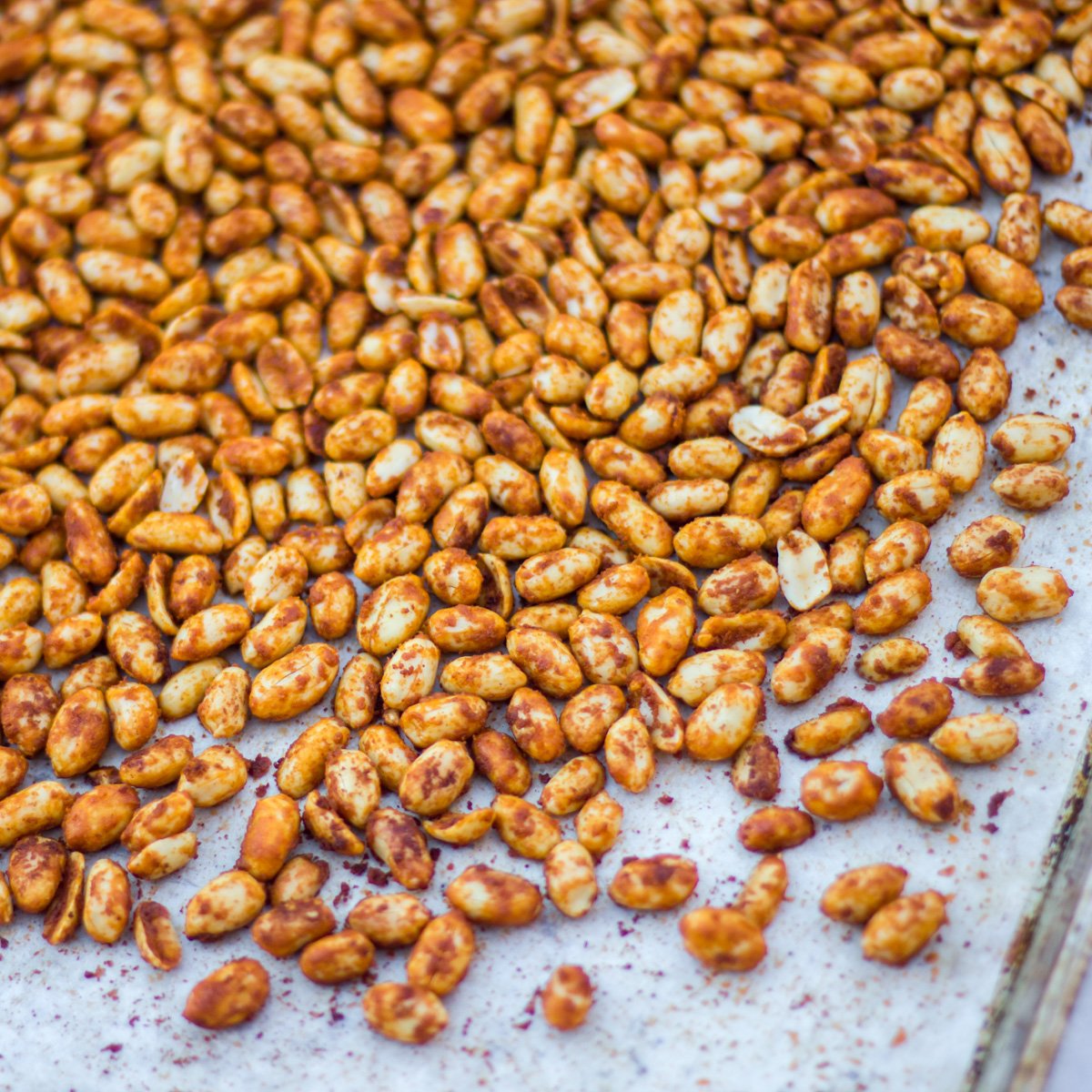 Overhead picture of roasted nuts on a baking sheet.