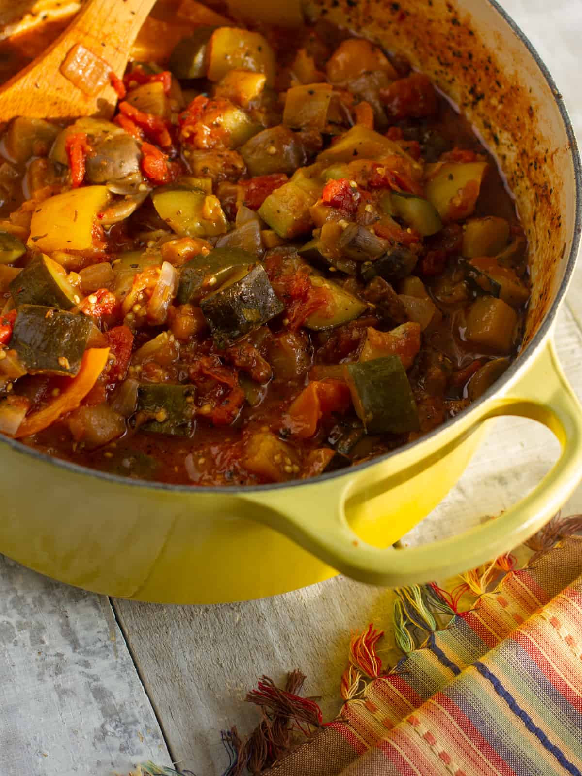 An overhead picture of a stewed ratatouille in a pot.