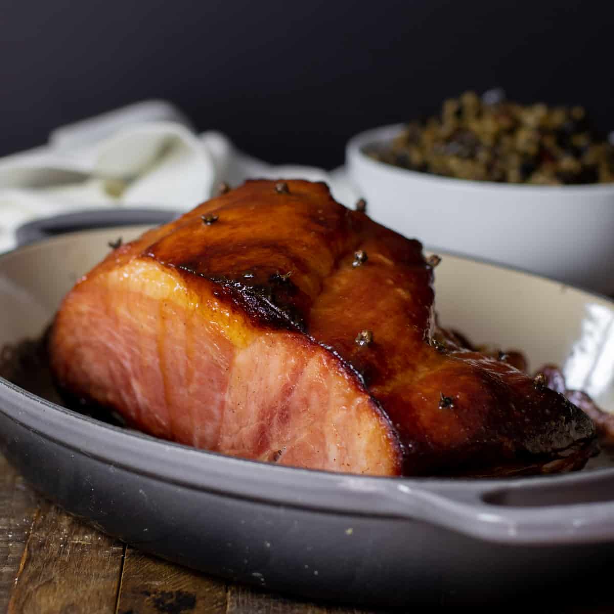 Baked ham out of the oven and ready to be sliced.