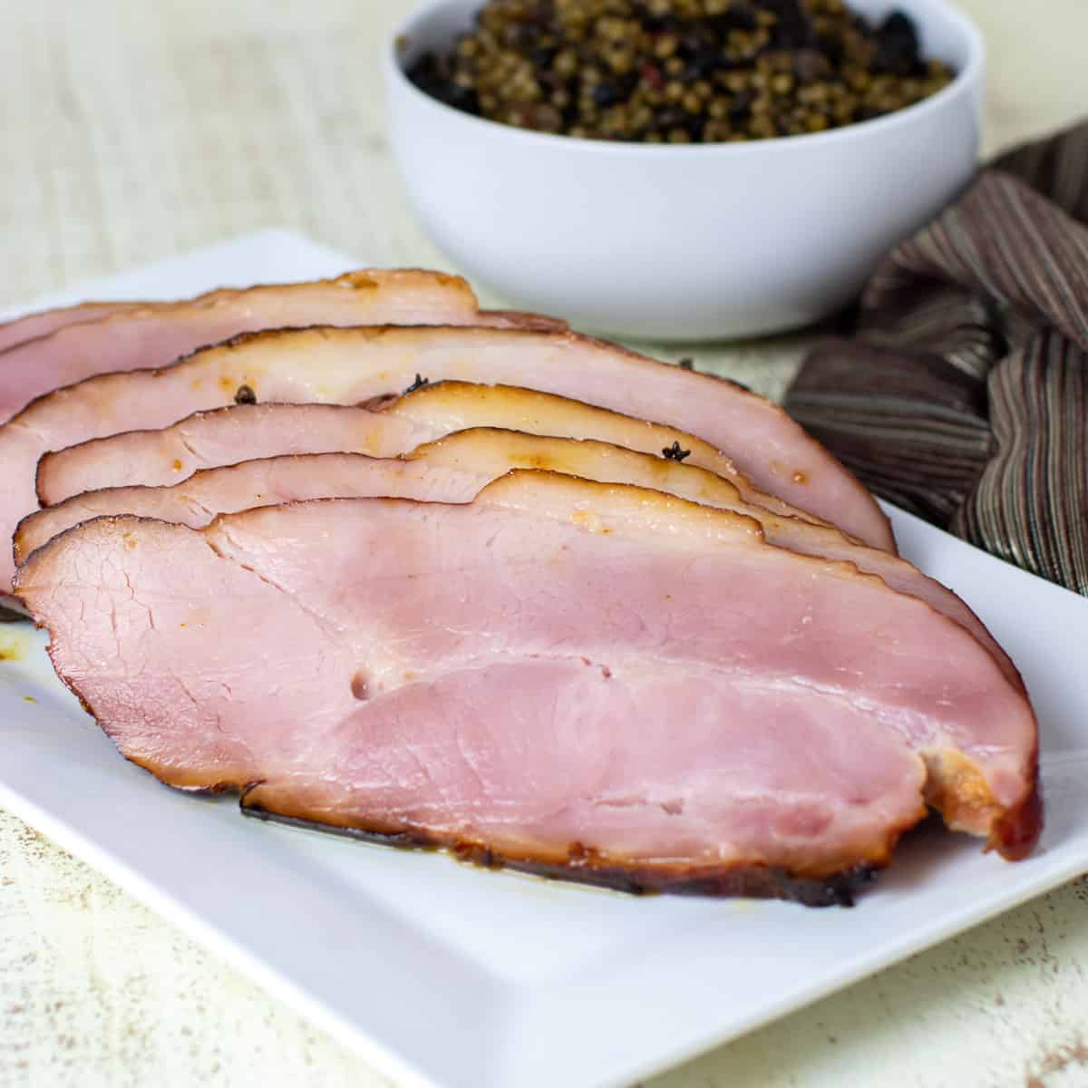 Sliced ham on a platter.