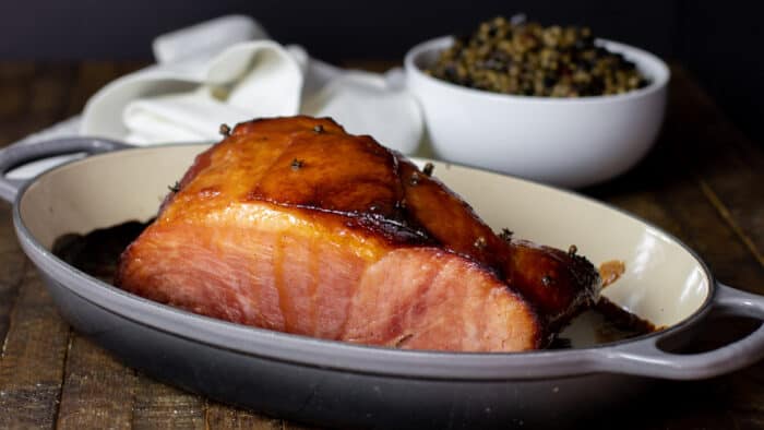 Baked ham in a roasting dish.