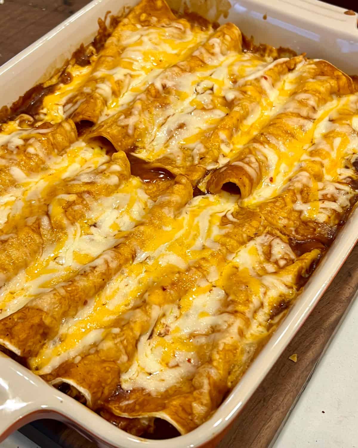 Baked Mexican enchiladas in a rectangular dish.