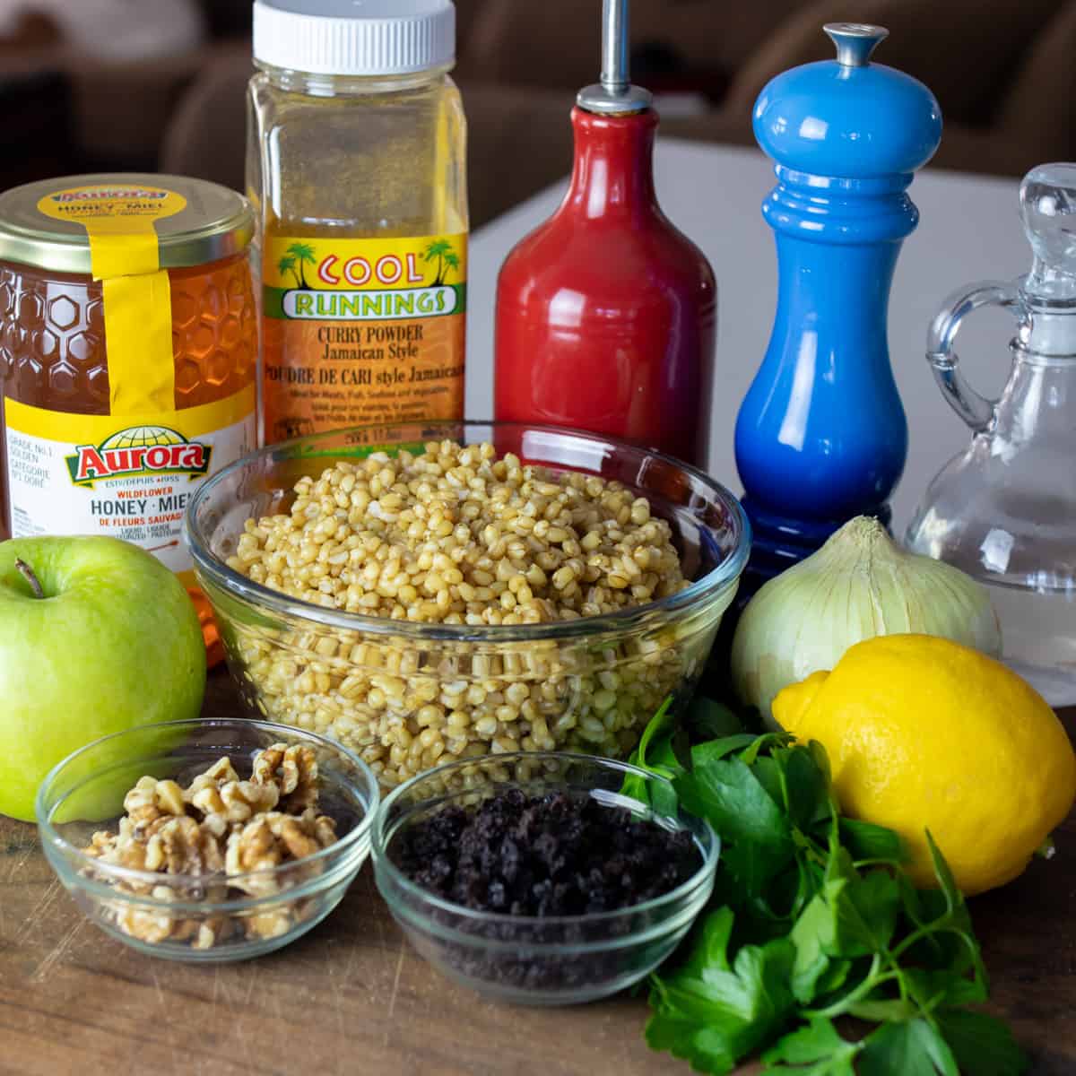 Ingredients for the wheat berry salad placed on a cutting board.