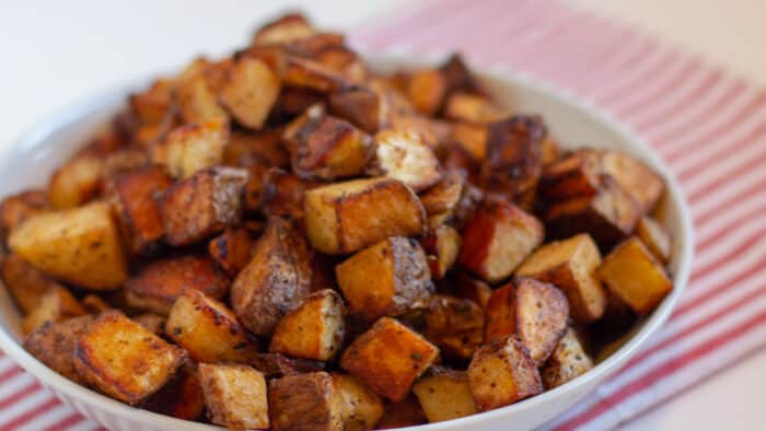 Tex mex potatoes that are in a white bowl.