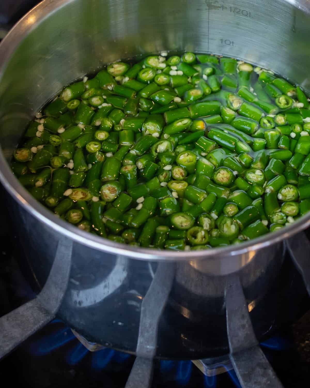 A pot of green chillies and vinegar.