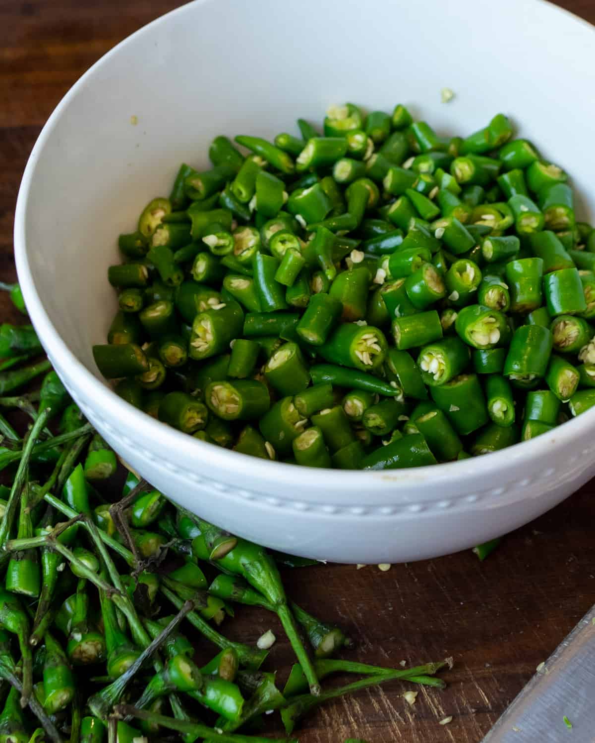 Chopped chillies in a white bowl.