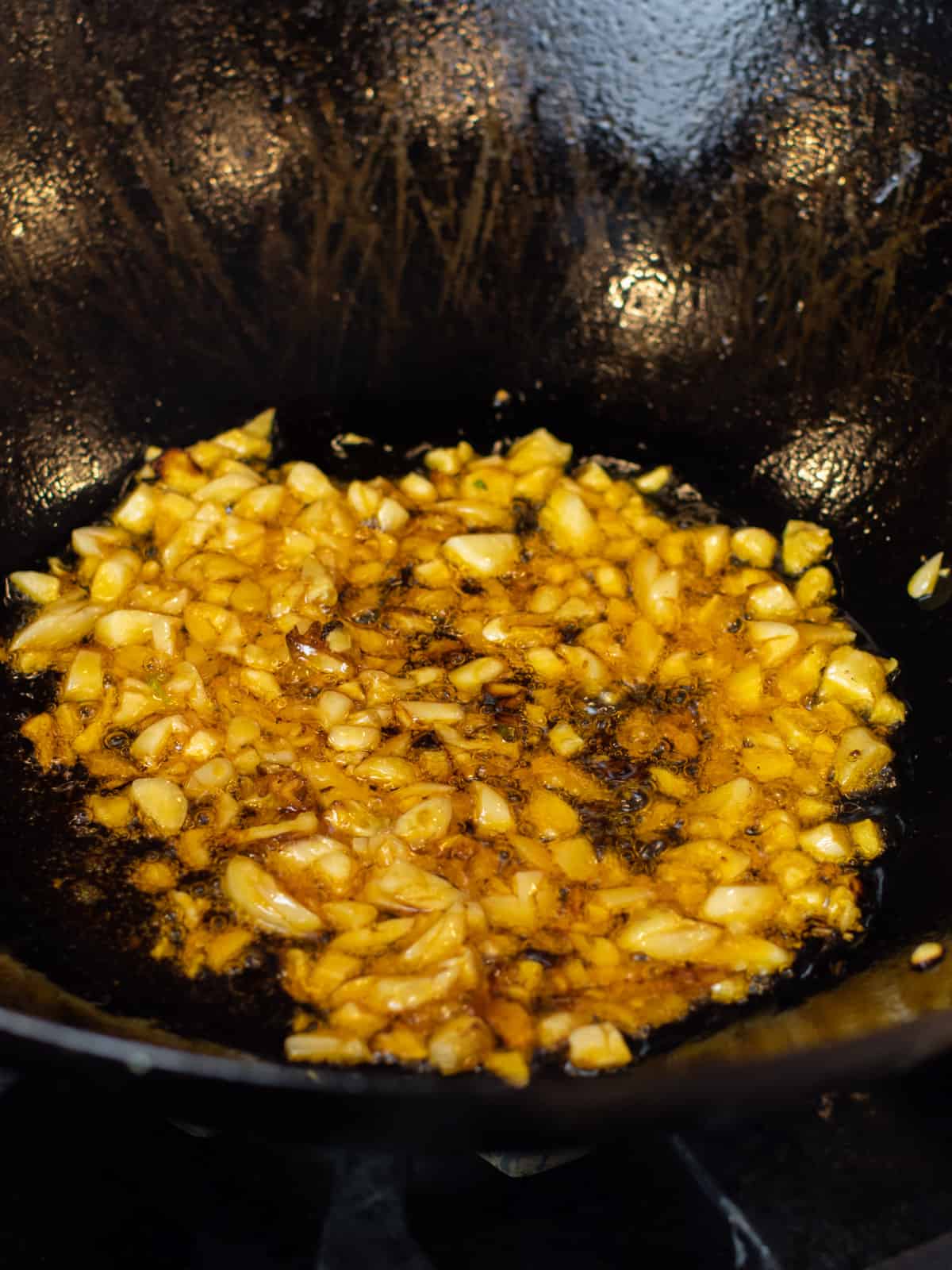 Chili oil with garlic in a wok.