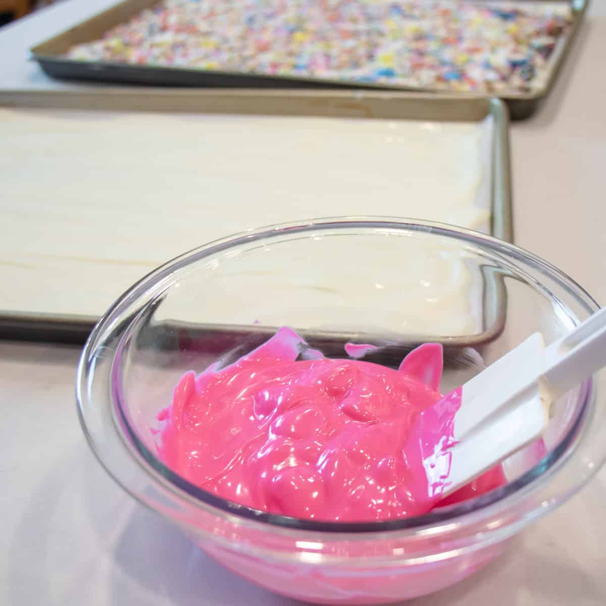 Pink candy melts in a glass bowl.