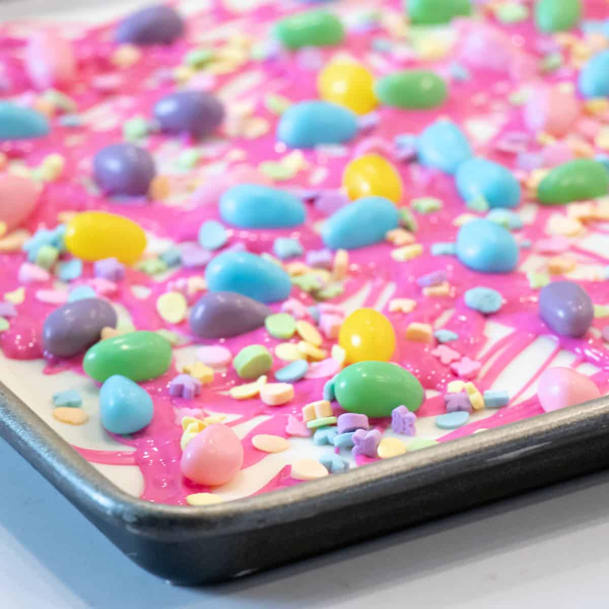 Spring coloured jelly beans on melted chocolate.