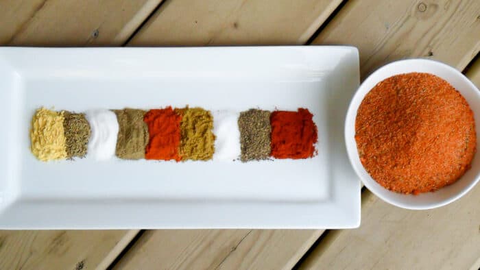 A bowl of mixed spices and a plate with them divided.