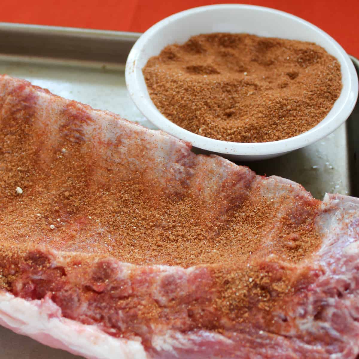 Back ribs with seasoning rubbed on it.