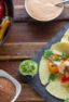 Overhead picture of assembled fajitas and a cast iron skillet.