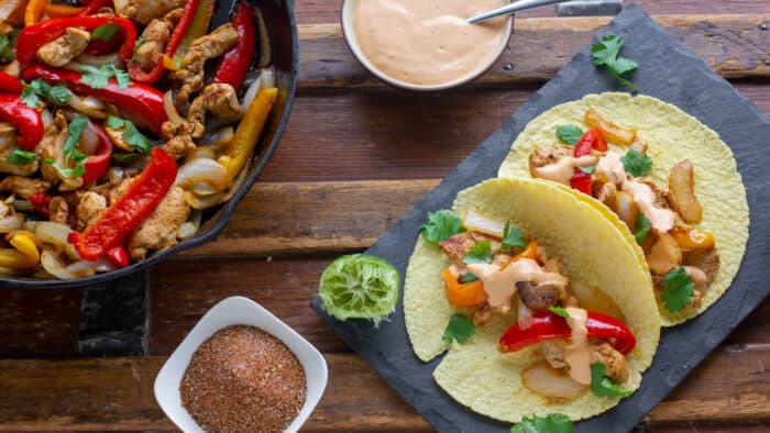 Overhead picture of assembled fajitas and a cast iron skillet.