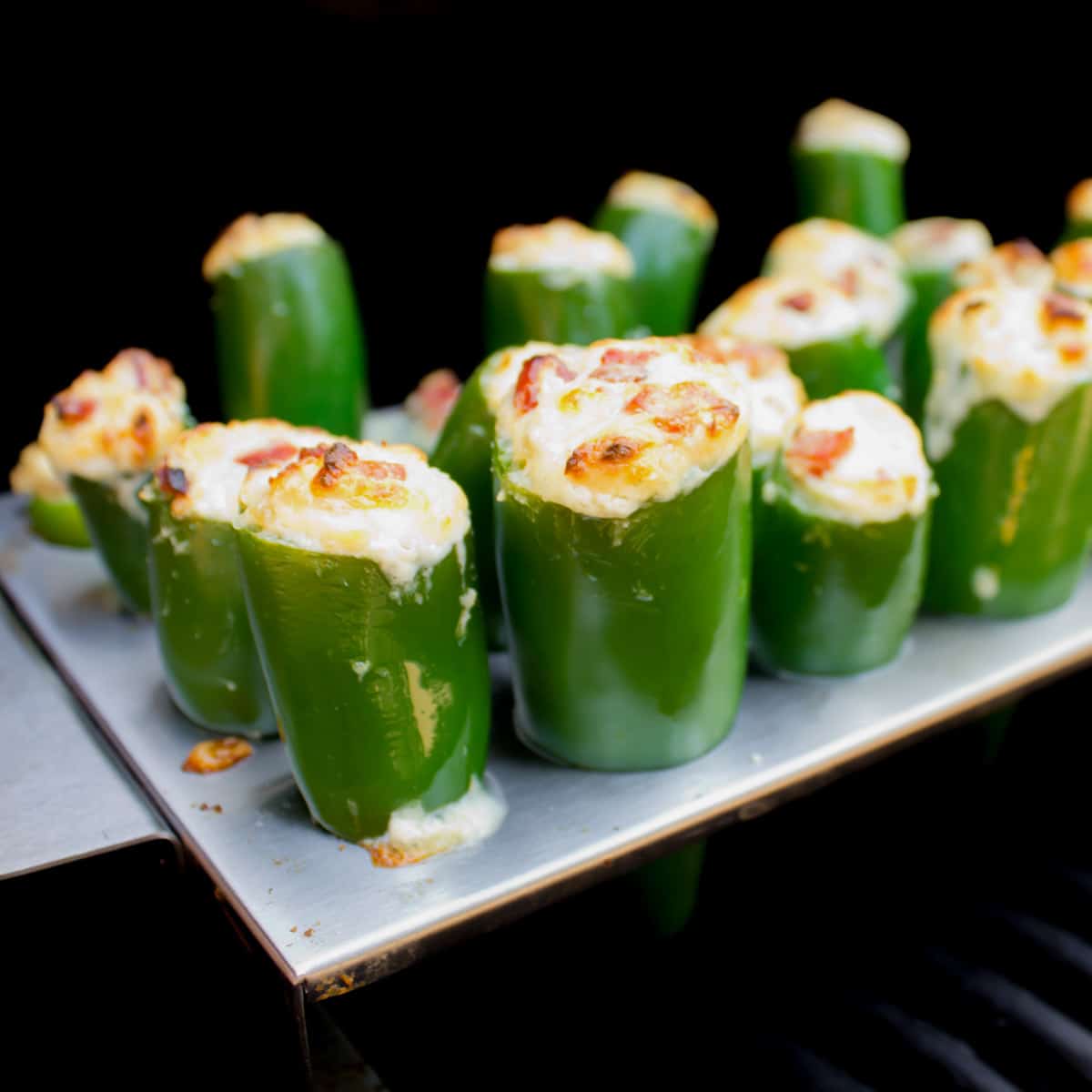 Stuffer jalapeno peppers on a grill.