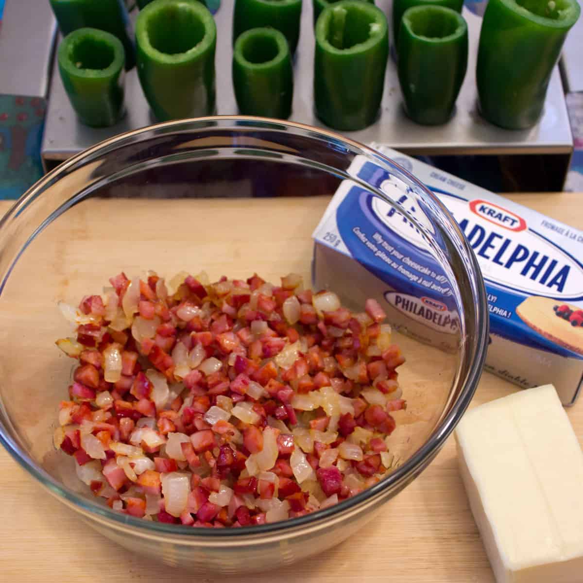 Sautéed onions and diced chorizo in a glass bowl.