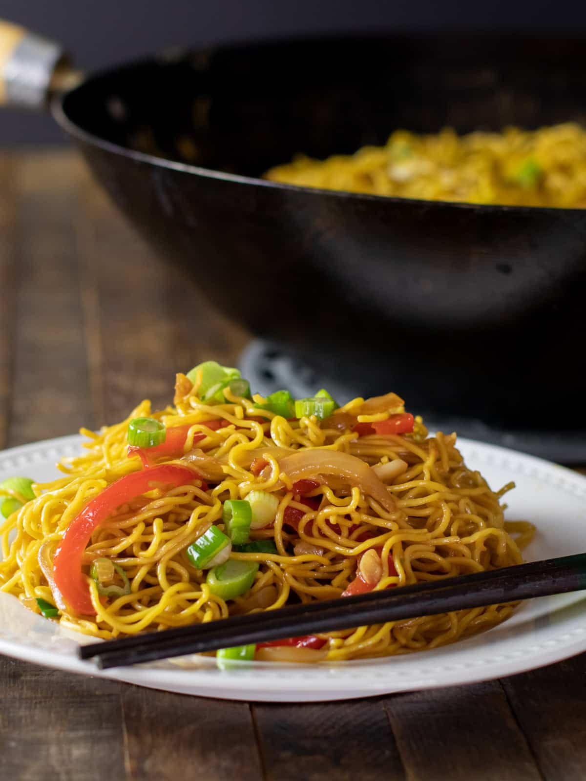 Chow mein noodles on a plate with chop sticks.