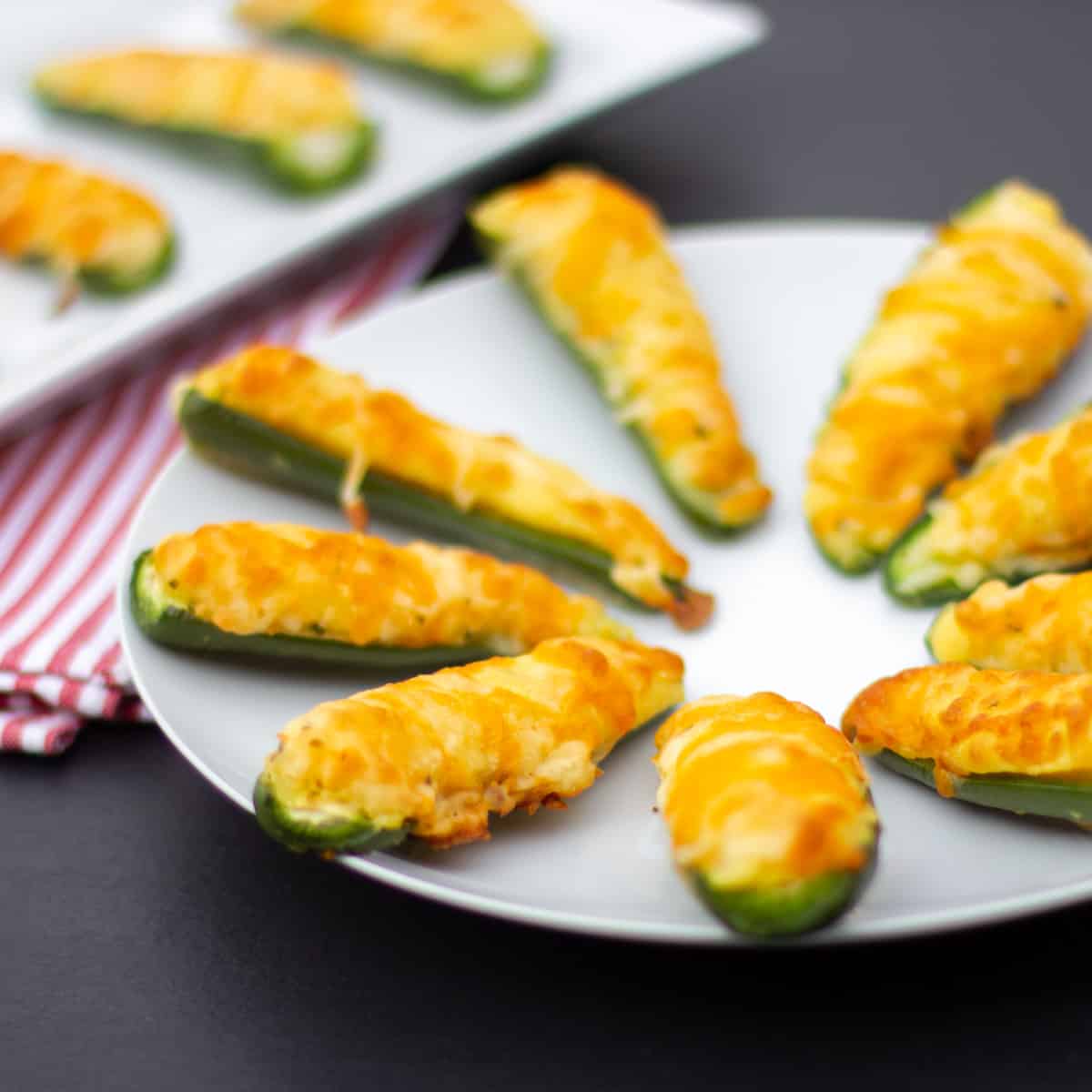 Jalapeno poppers on a round plate.
