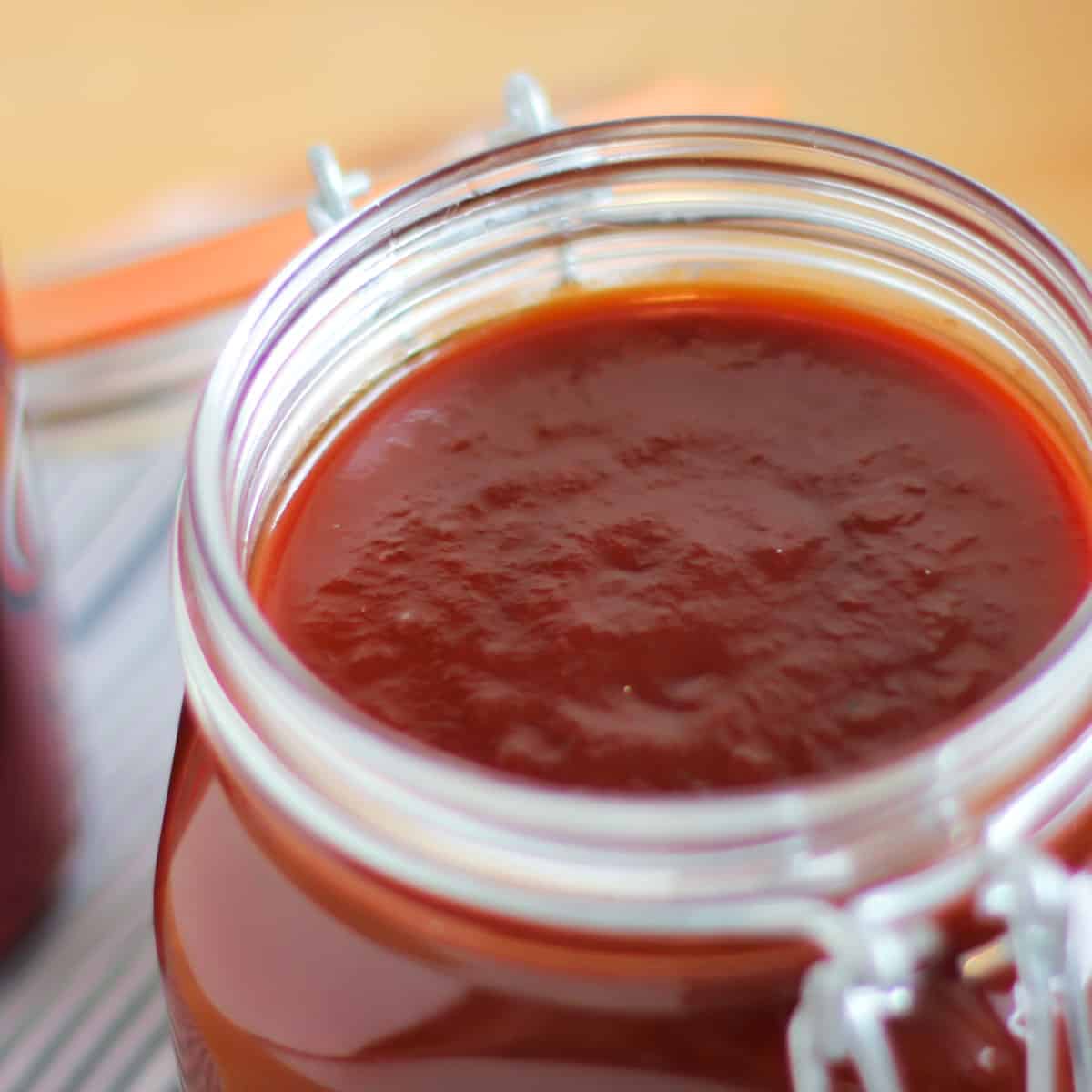 A close up picture of a jar of 
BBQ sauce.