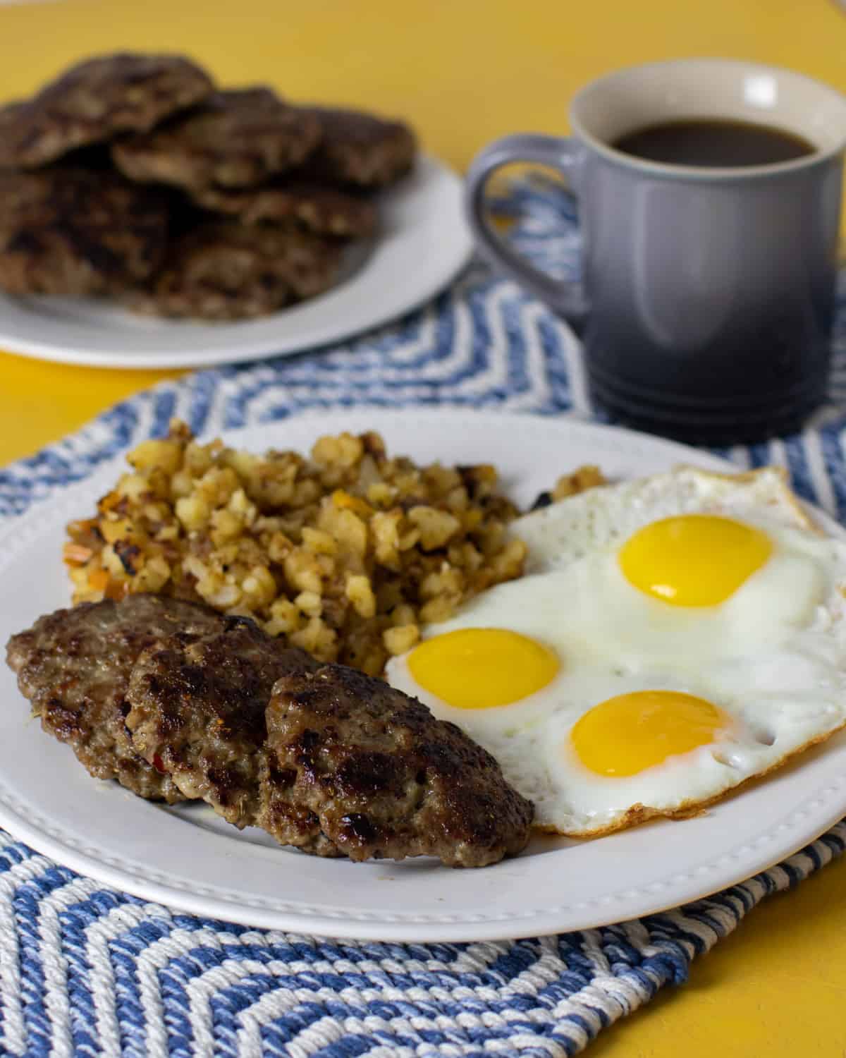 An overhead picture of a full breakfast plate next to a mug of coffee.