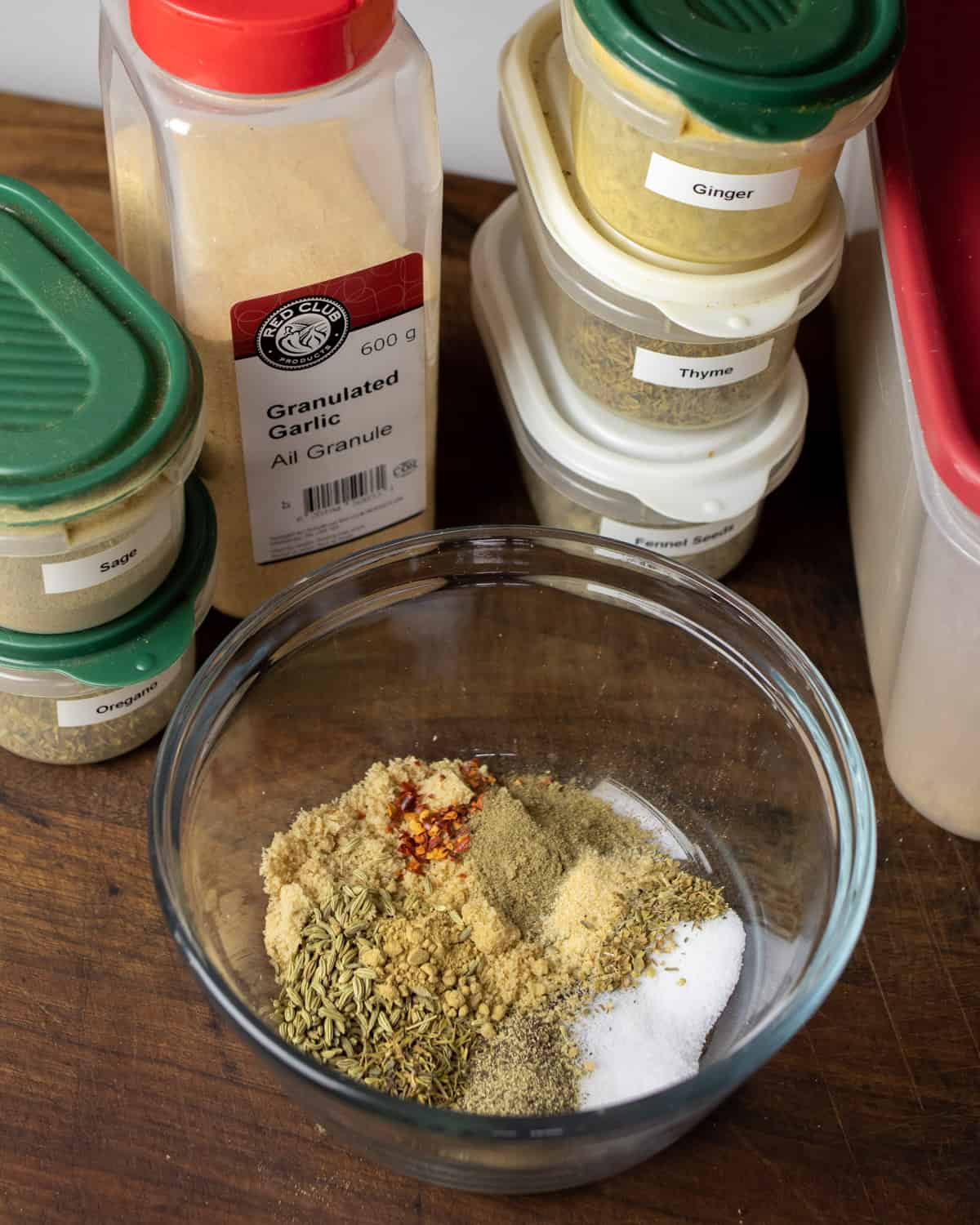 Spices added to a glass mixing bowl.