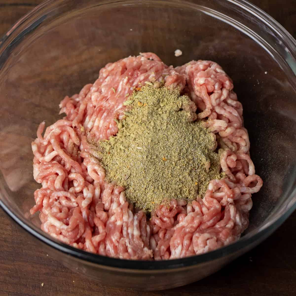 Ground pork with sausage seasoning dumped on top.