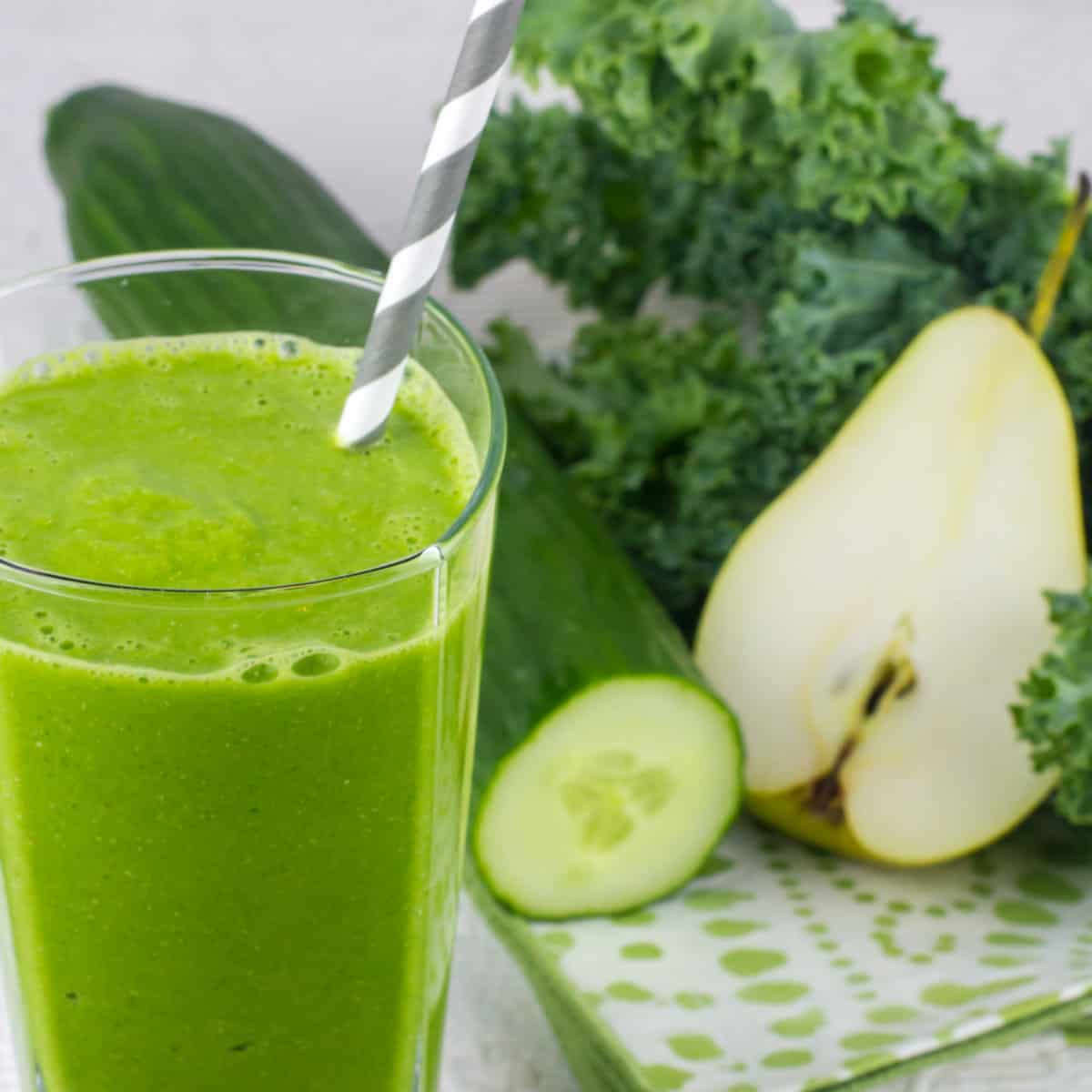 Cucumber and pear next to a smoothie.