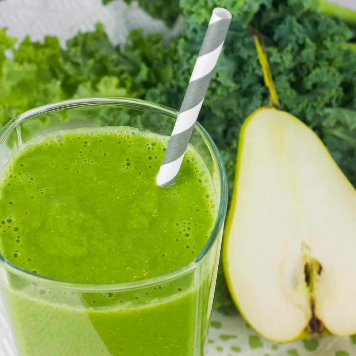 Close up overhead picture of a glass full of a green smoothie.