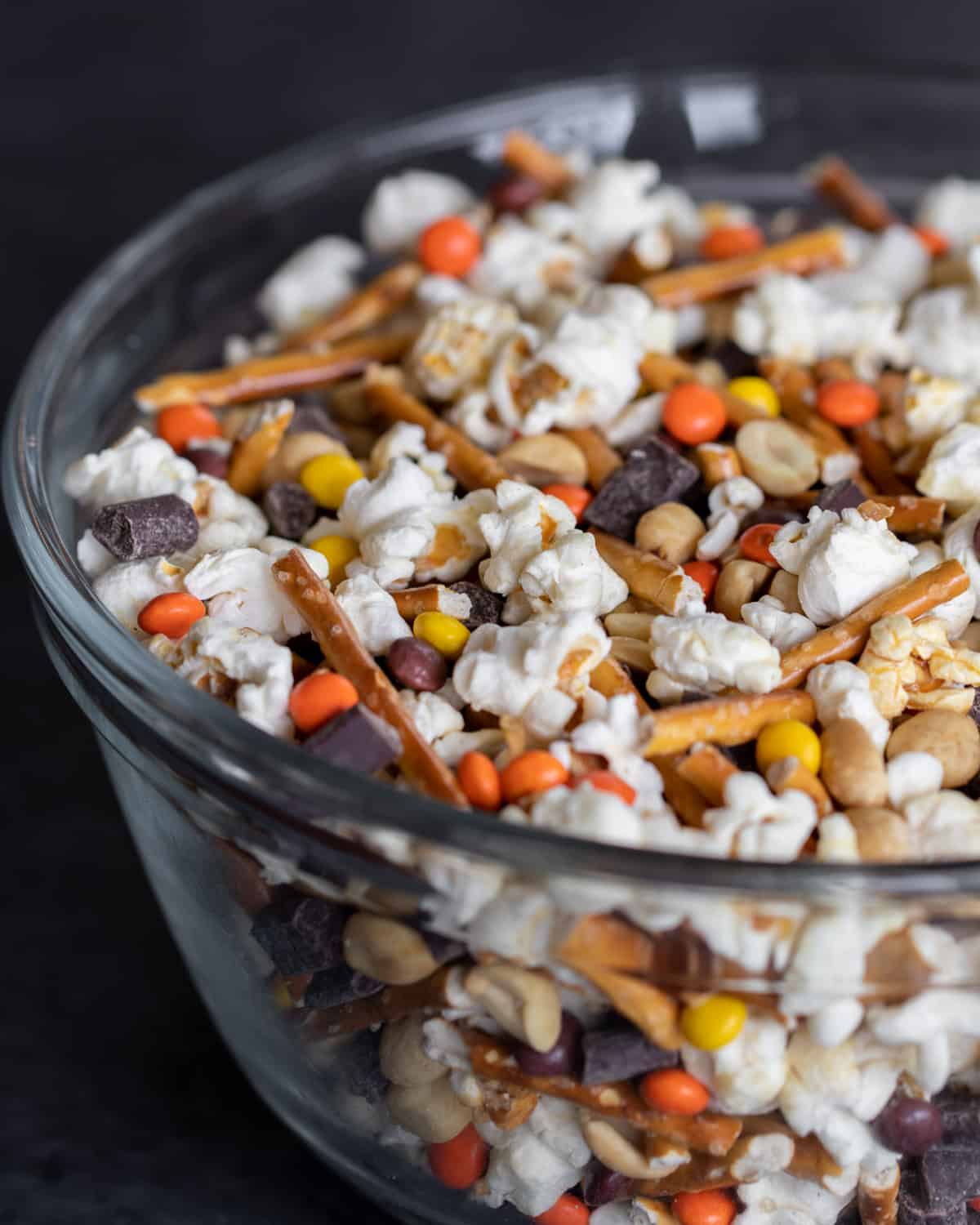 A glass mixing bowl filled with snacks.
