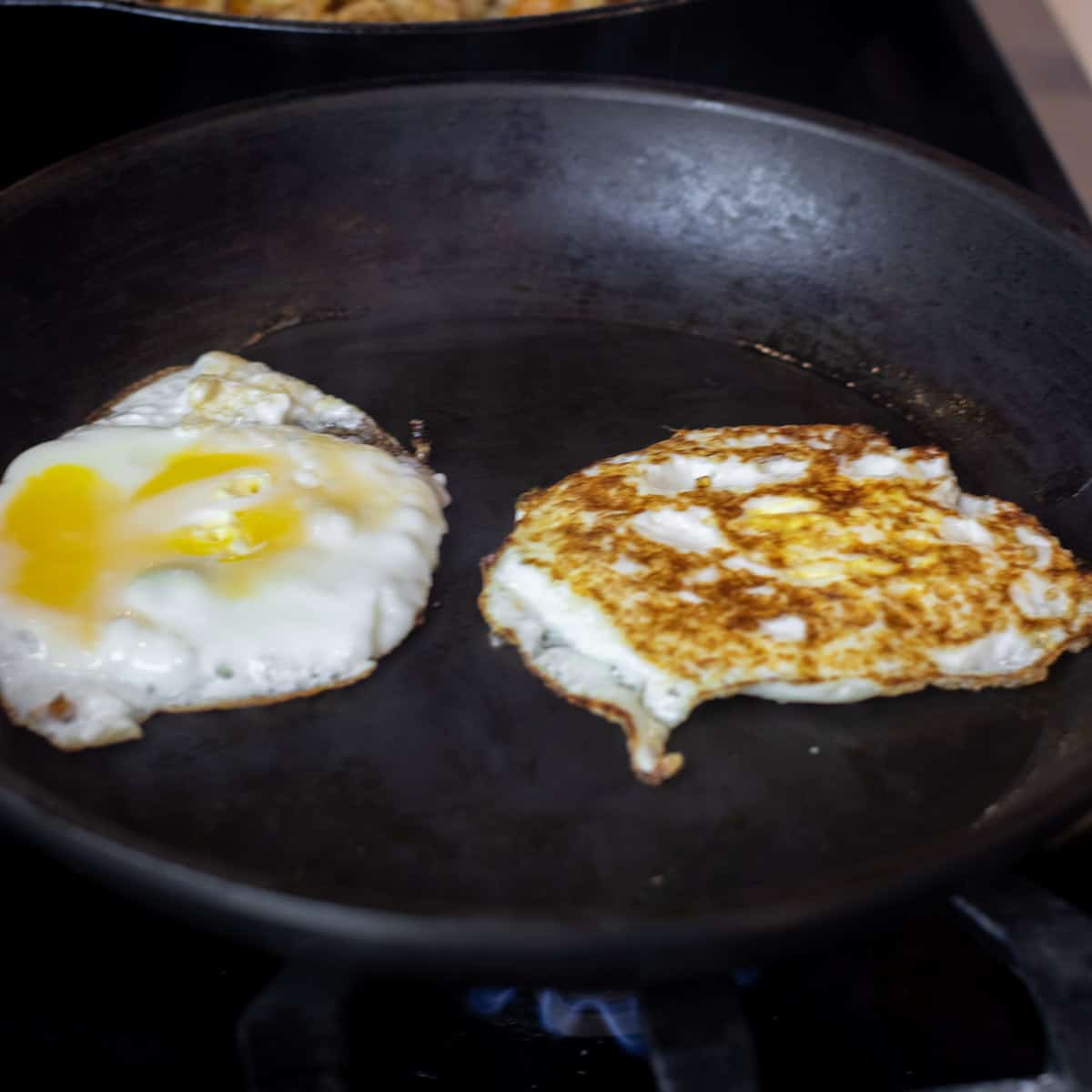 Fried eggs in a skillet.