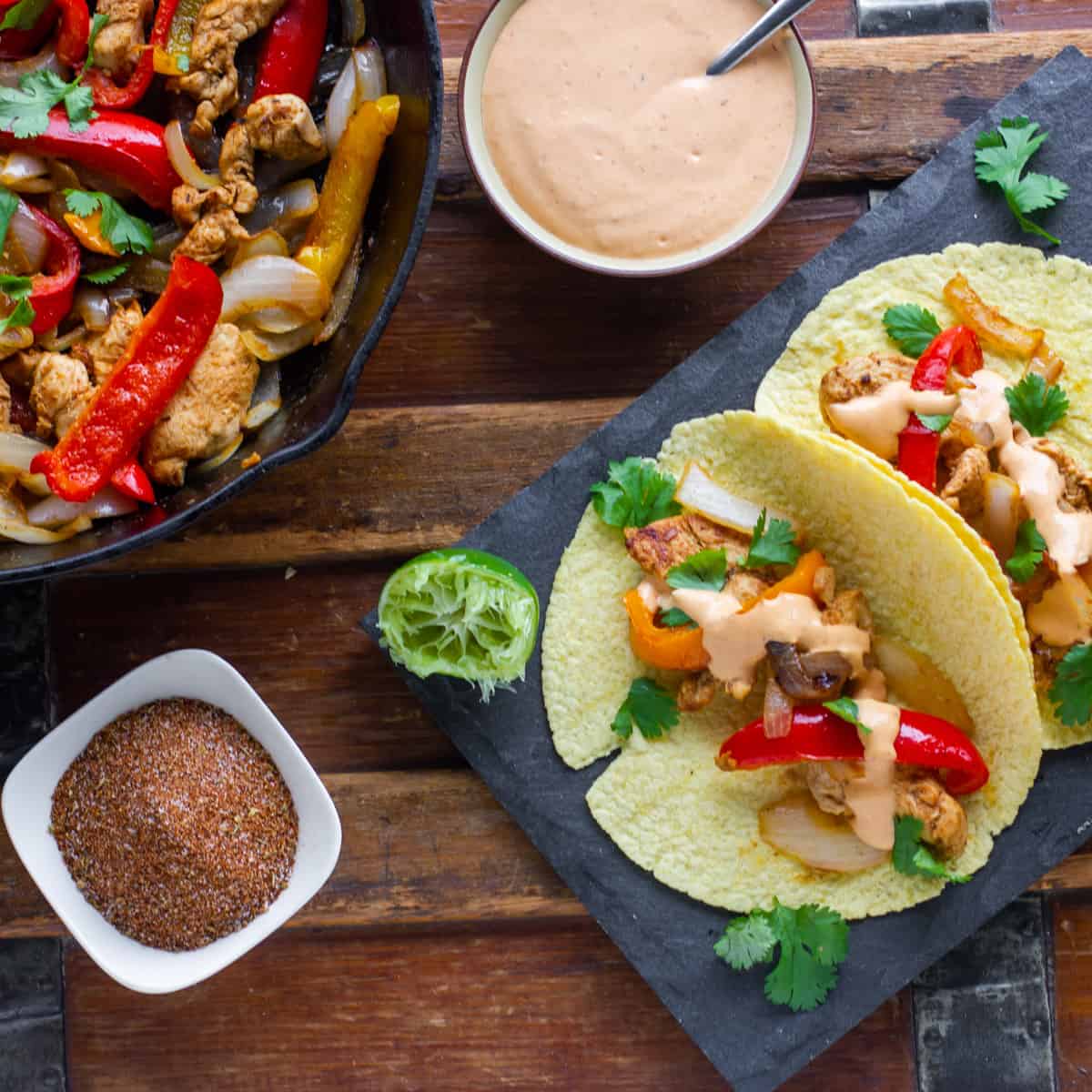 Chicken fajitas on a slate.