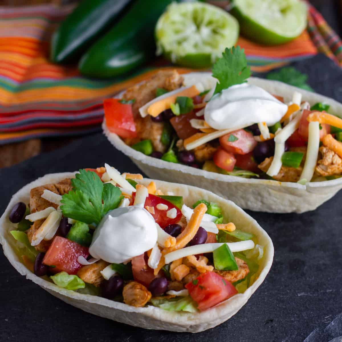 Taco bowls filled with toppings.