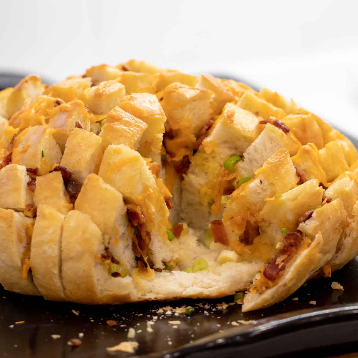 Pull apart bread on a baking stone with about one quarter of the bread gone.