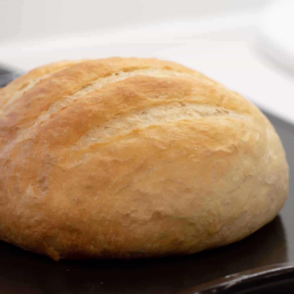 A fresh loaf of round artisan bread.