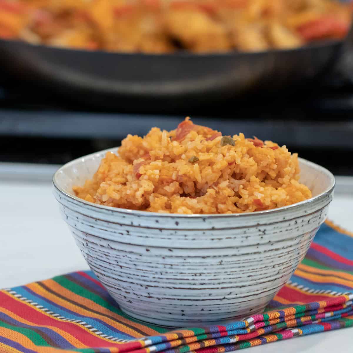 A bowl of mexican cheese rice.