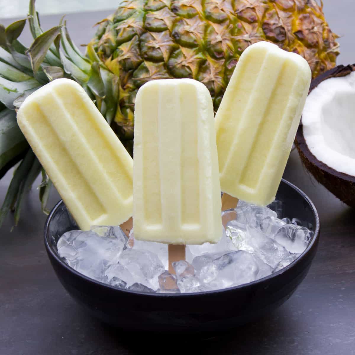 Three popsicles in a bowl of ice.