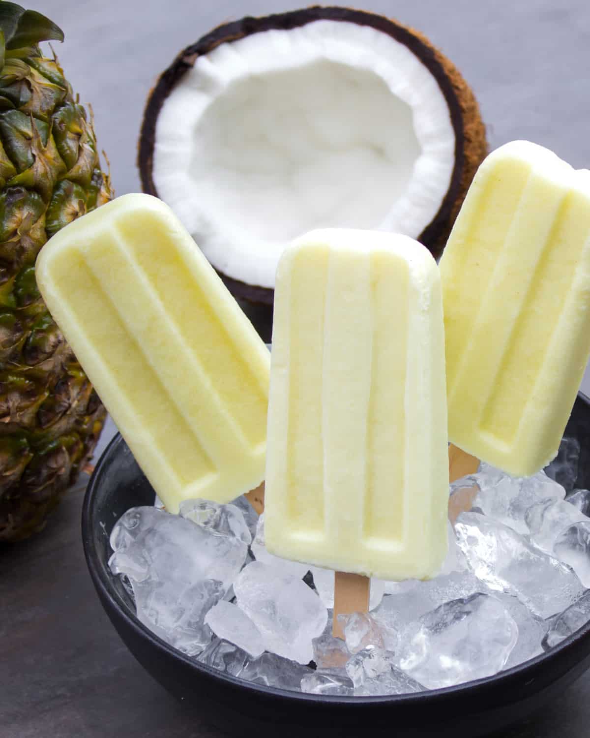 Popsicles in a bowl filled with ice.