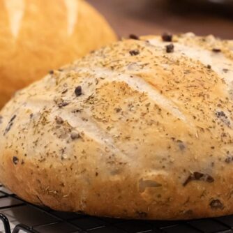 Two Loaves of rustic round bread on a cooling rack.