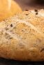 Two Loaves of rustic round bread on a cooling rack.