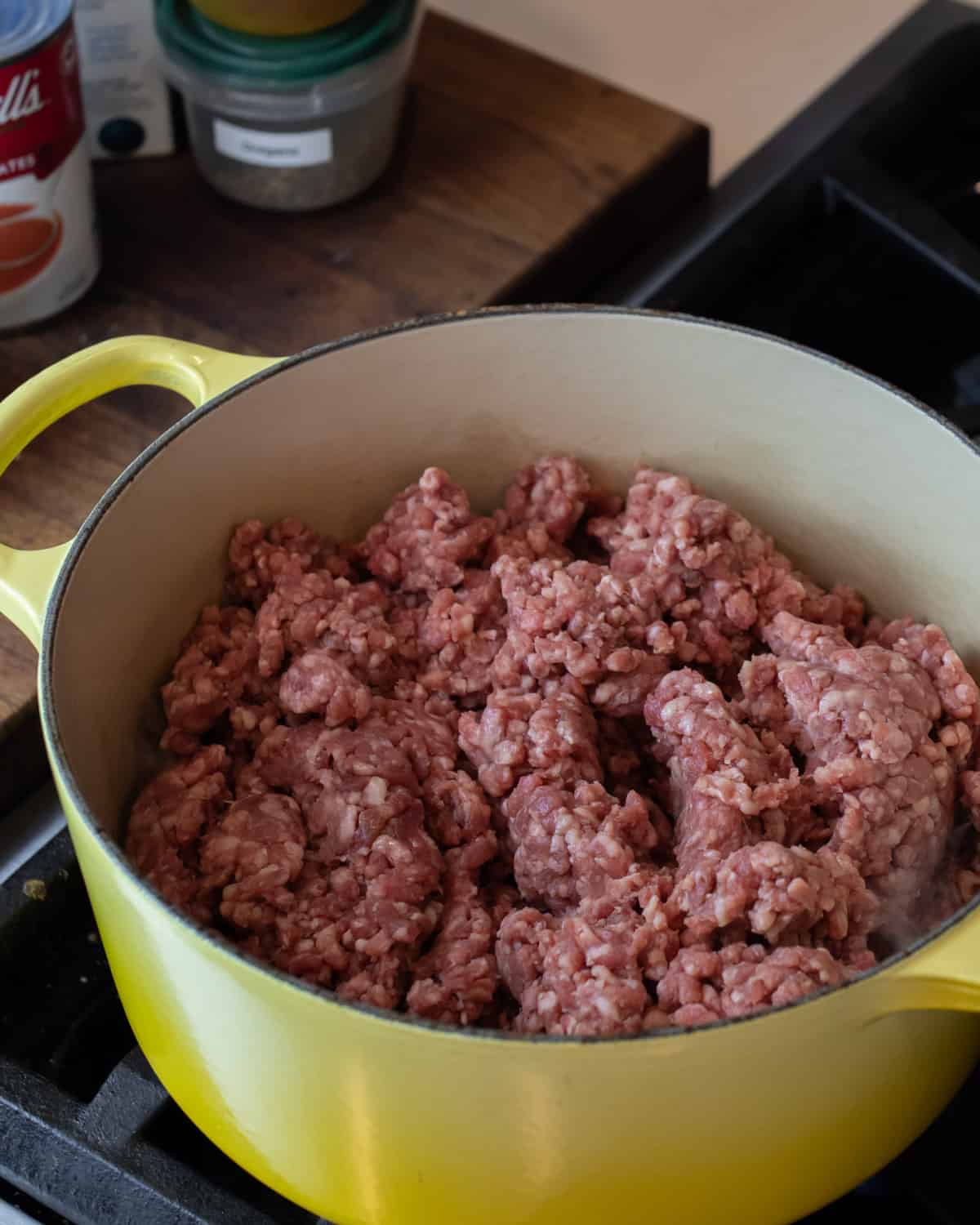 Raw ground beef in a dutch oven.