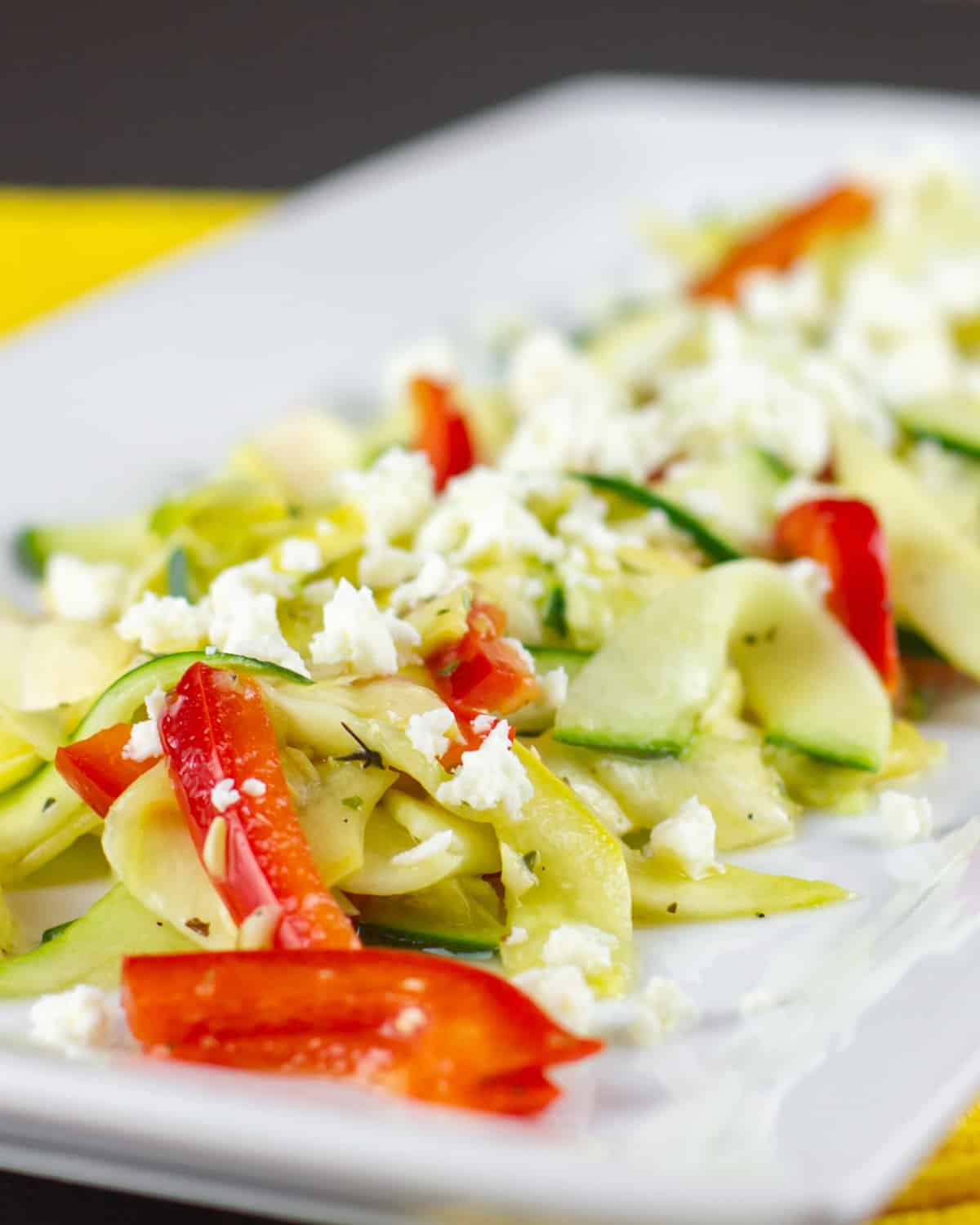 A vegetable salad with crumbled feta cheese.