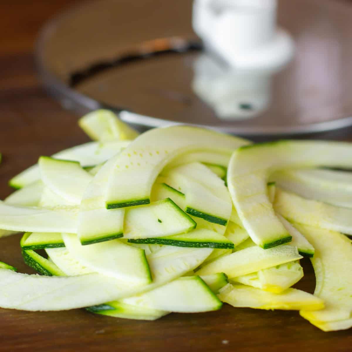 Zucchini and yellow squash sliced into thin strips.