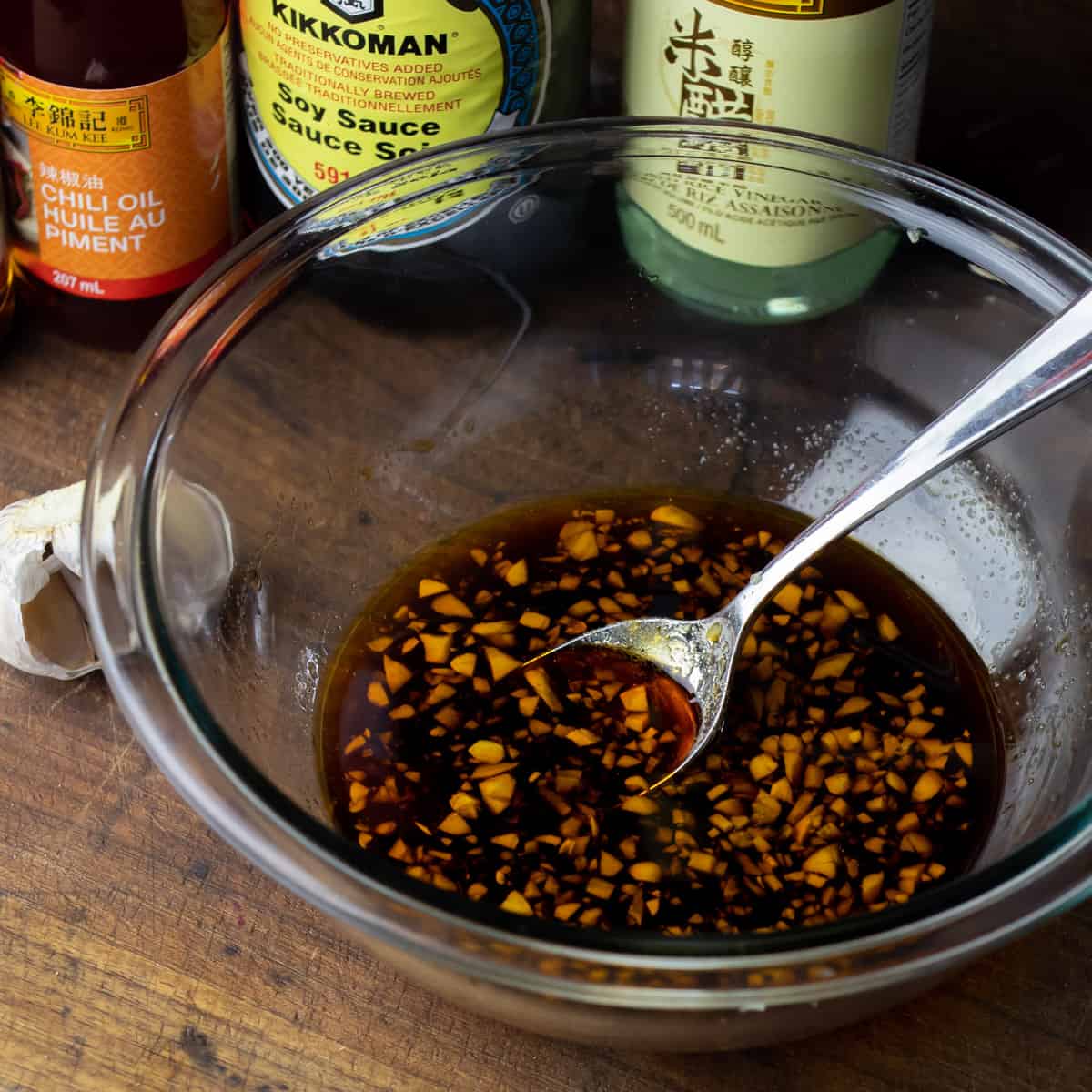 Dipping sauce ingredients added to a glass mixing bowl.