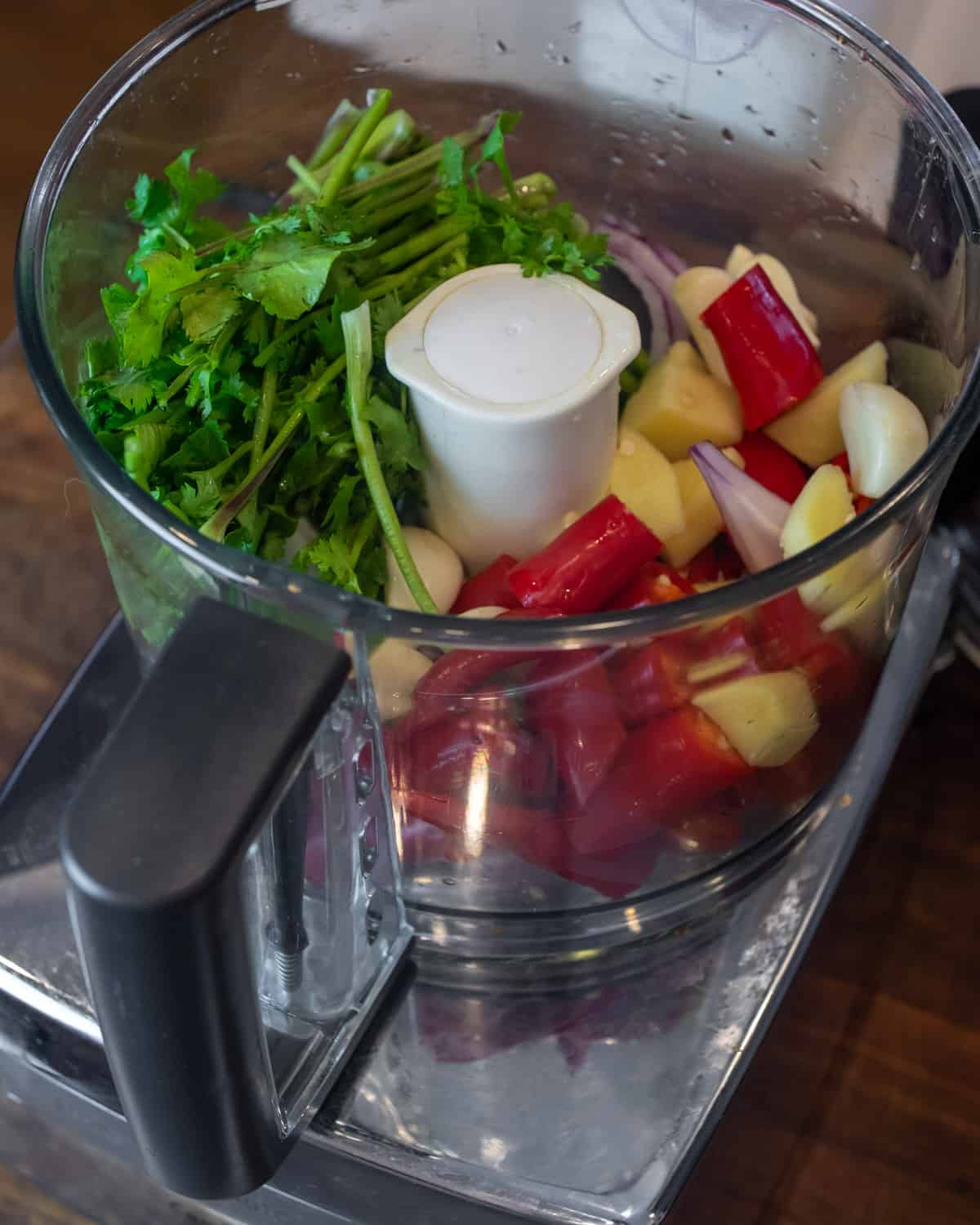 Chili peppers, cilantro, ginger and garlic in a food processor bowl.
