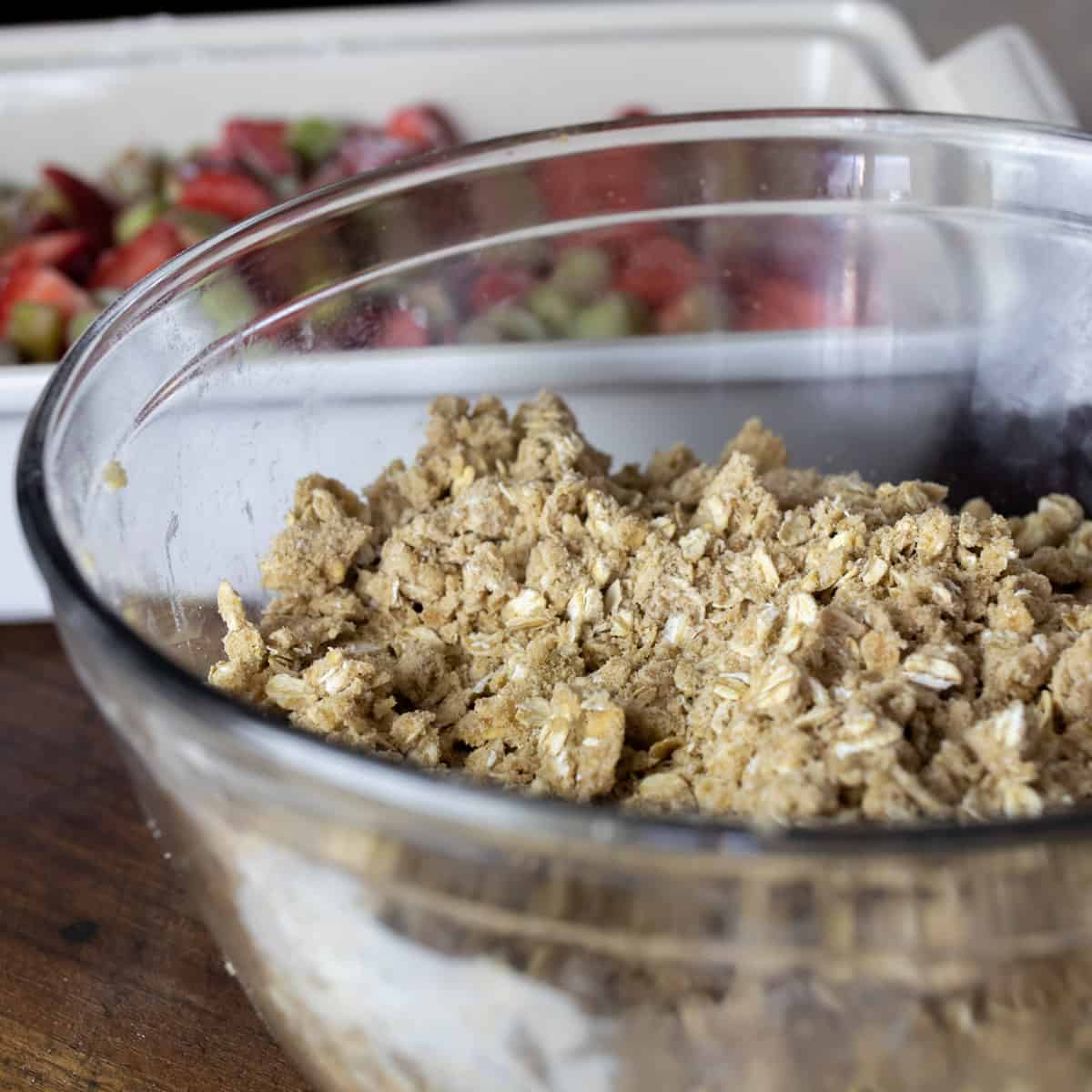 Crumble topping mixed in a large glass baking dish.