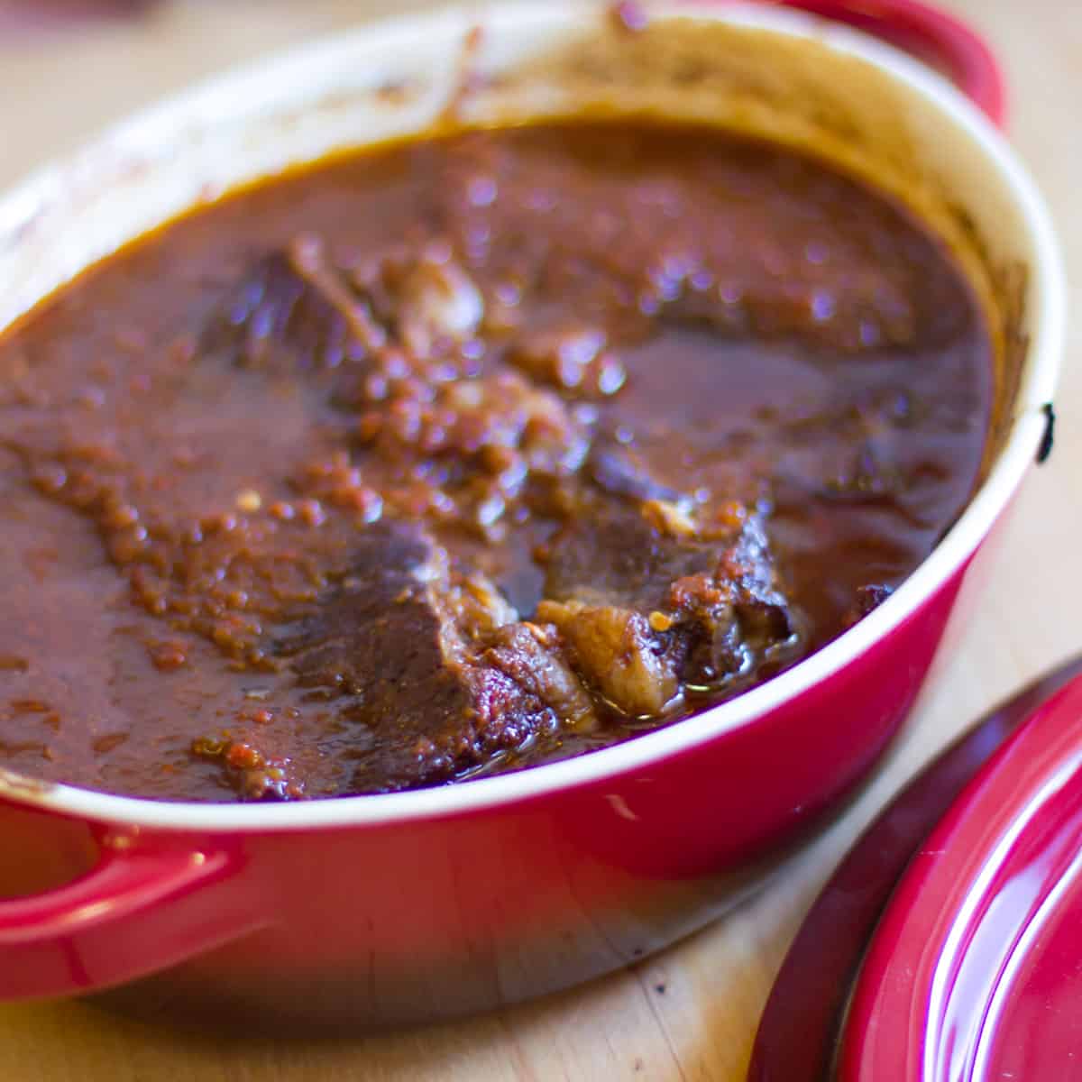 Baked beef with sauce in an oval dish.