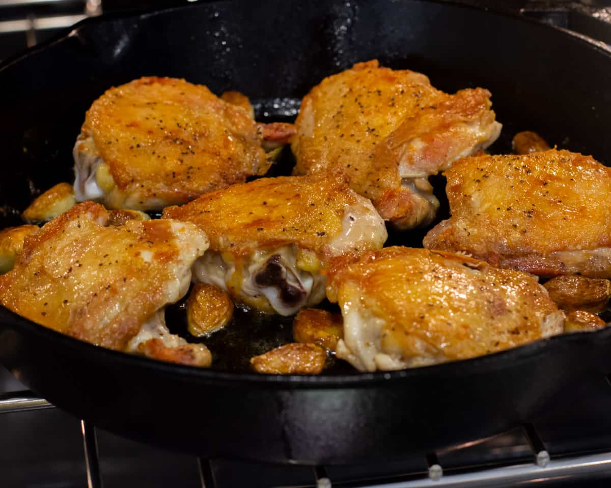 Baked chicken thighs with roasted garlic.